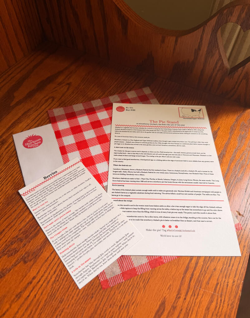A photo of the mail club content splayed on a butcher block counter top.